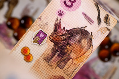 Card with a triceratops illustration and paw print symbols on a blurred background